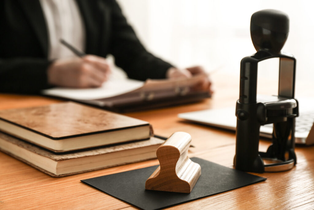 Books and stamps on table of notary public